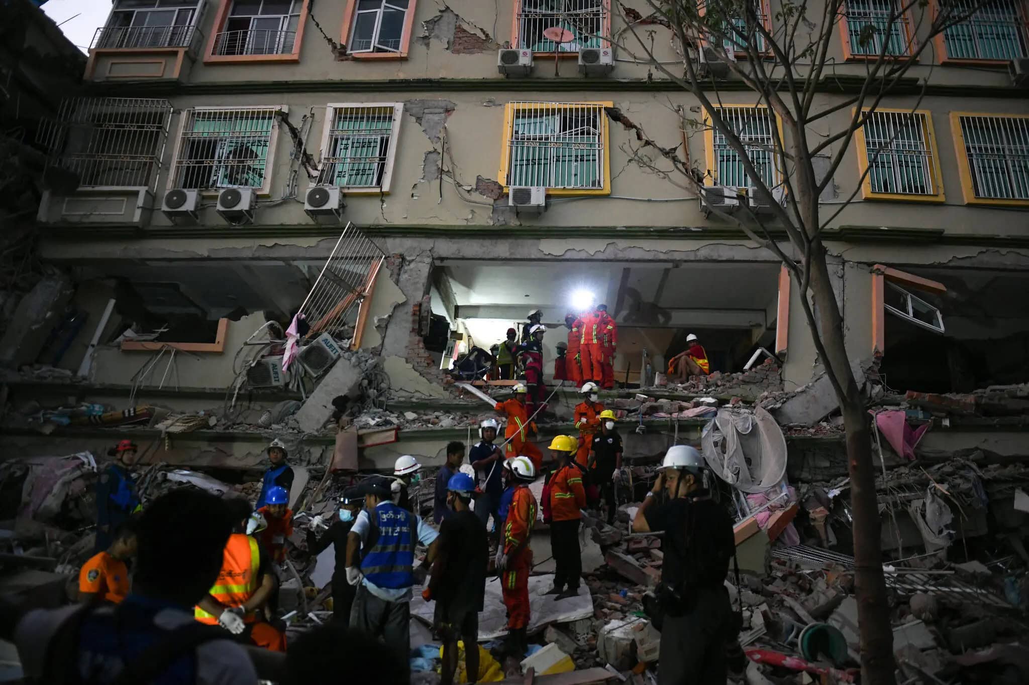 Rescue workers from Myanmar and China search through collapsed debris at Sky Villa in Mandalay following the earthquake.