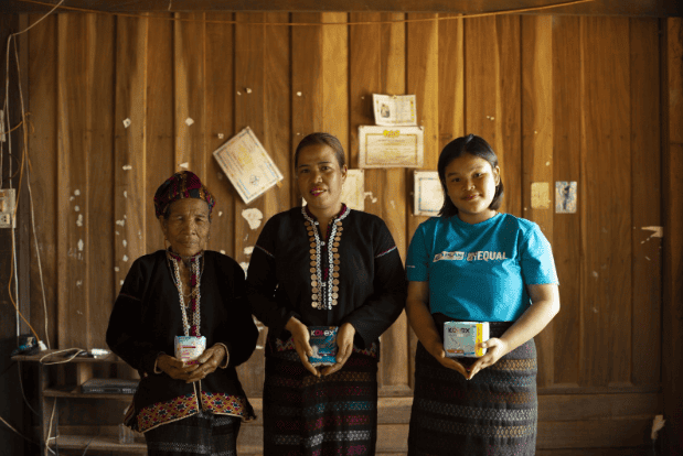 Three generations of women in Vietnam stand together holding Kotex® pads, representing changing attitudes toward menstruation.