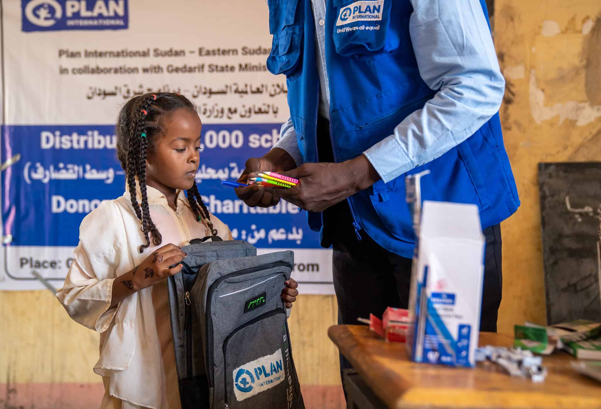 A girl in Sudan receiving school supplies