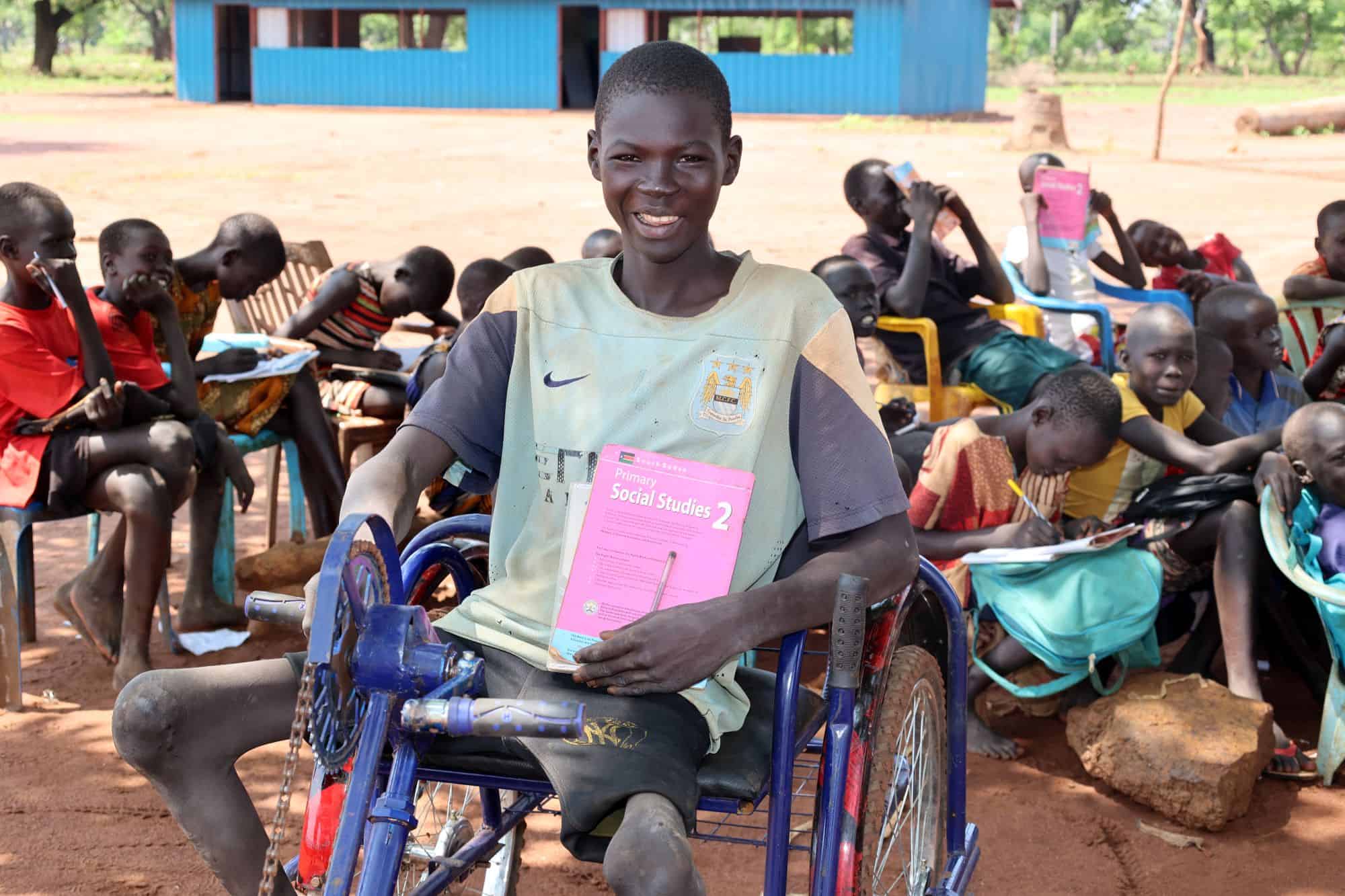 Teenage boy in wheelchair at school