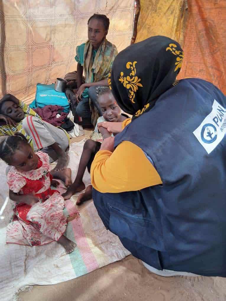 Plan International staff with displaced children in Tawila