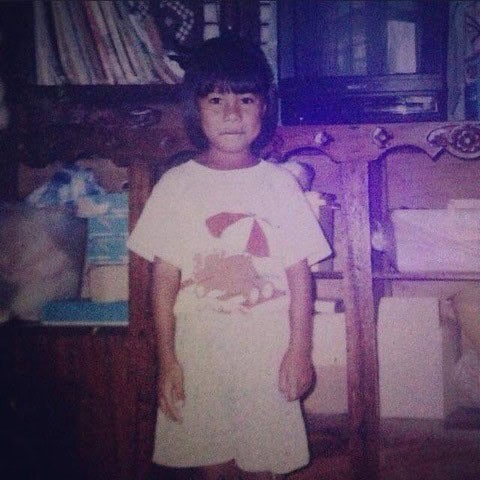 El looks at the camera, back when she was participating in Plan's sponsorship program.