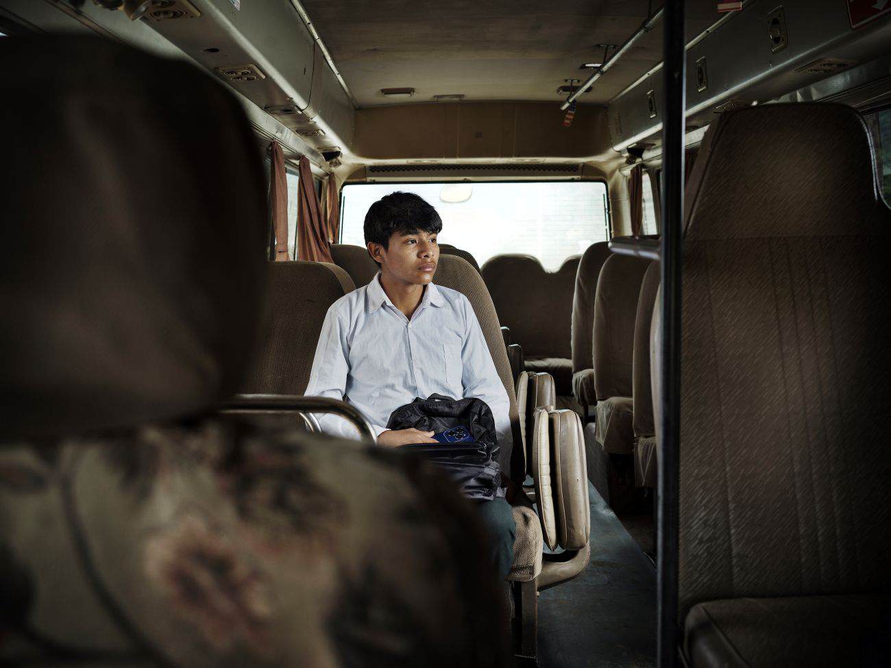 Miguel works in the fields after returning home from boarding school in Bolivia