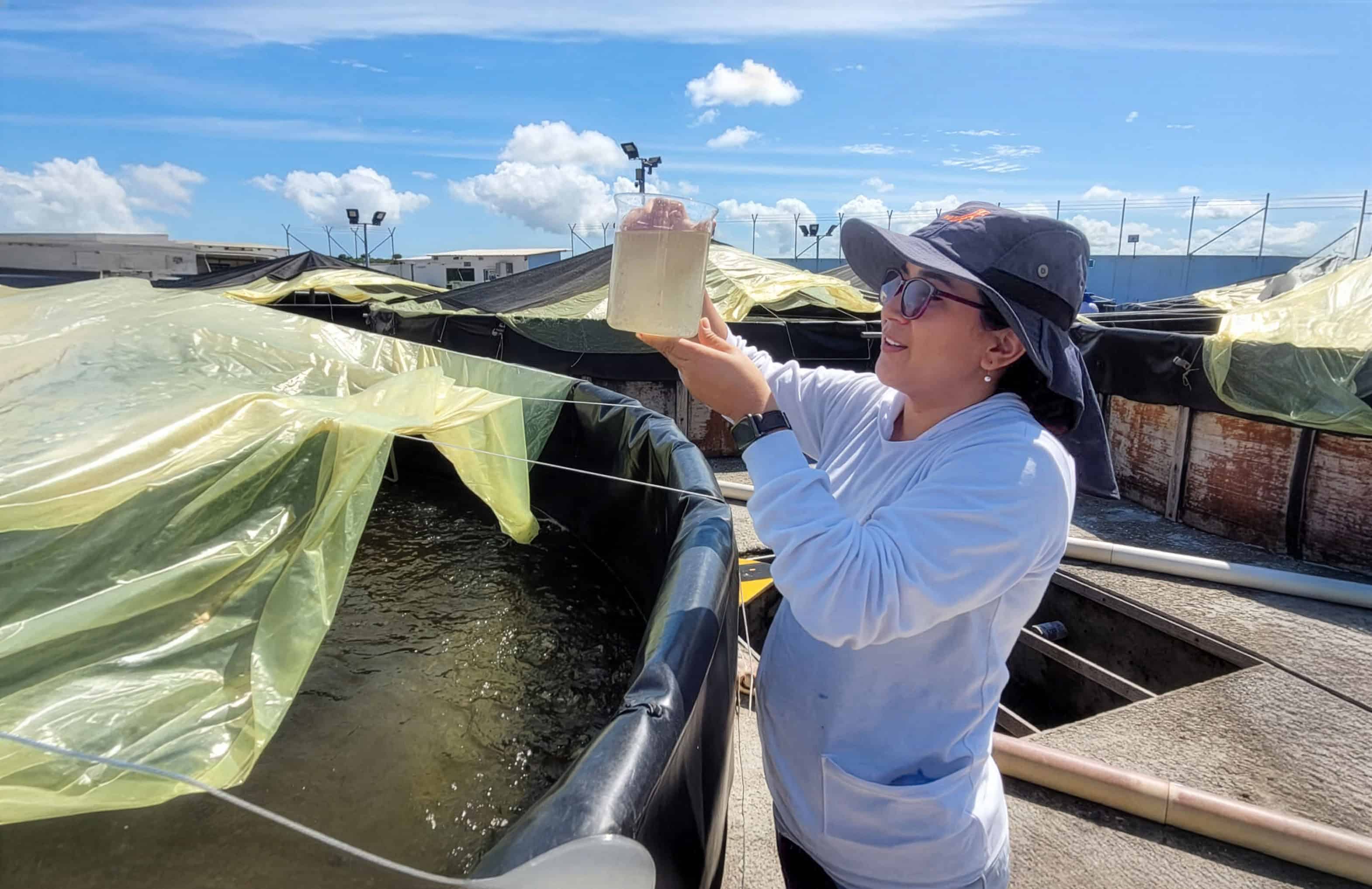 Valeria examines a sample at a microbiology facility in Santa Elena, Ecuador