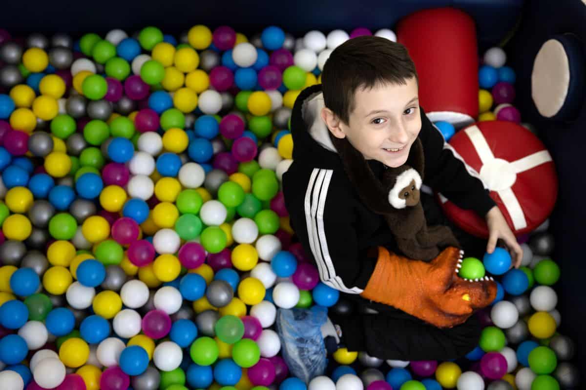 Damir, 8, plays in a ball pool at a child-friendly space in Kropyvnytskyi, Ukraine.