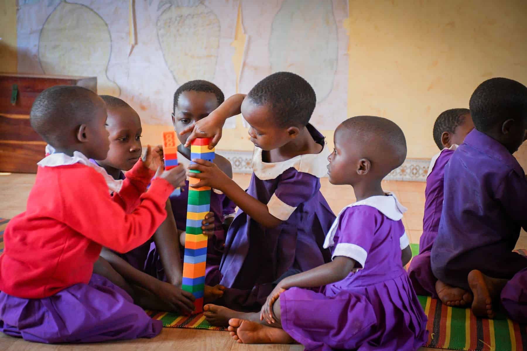 Children work together using colorful building blocks during a classroom activity in Kibondo District, Tanzania.